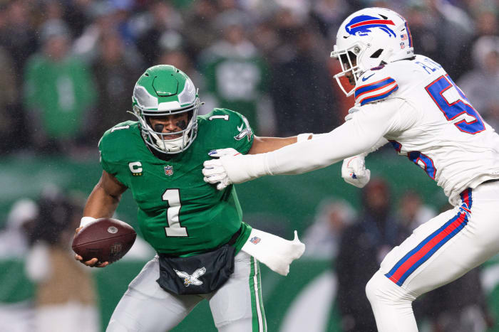 Philadelphia Eagles quarterback Jalen Hurts (1) eludes Buffalo Bills defensive end Leonard Floyd (56) during the first quarter at Lincoln Financial Field.
